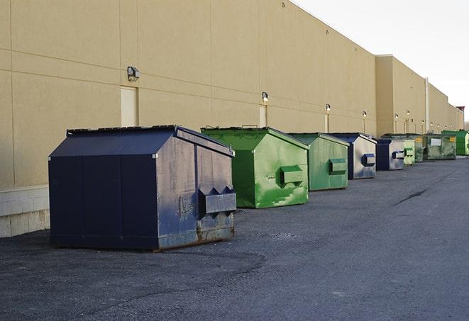 a group of dumpsters lined up along the street ready for use in a large-scale construction project in Claymont